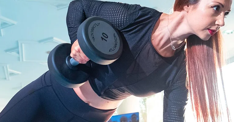a person lifting weights with a blue background
