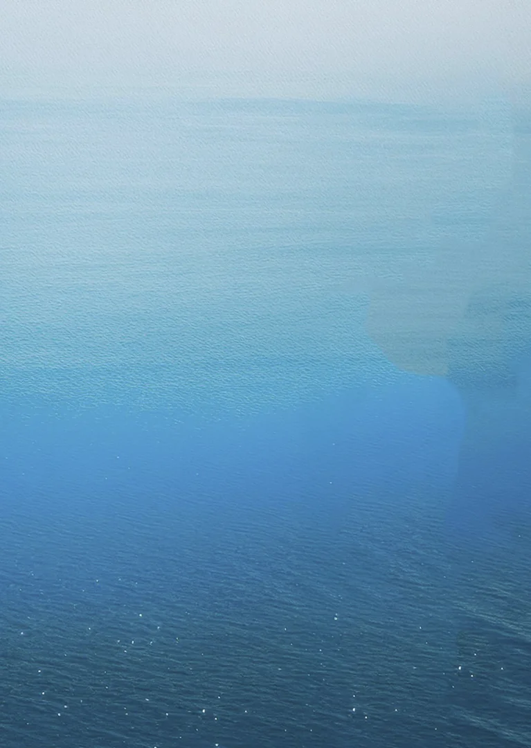 a blue ocean with white clouds
